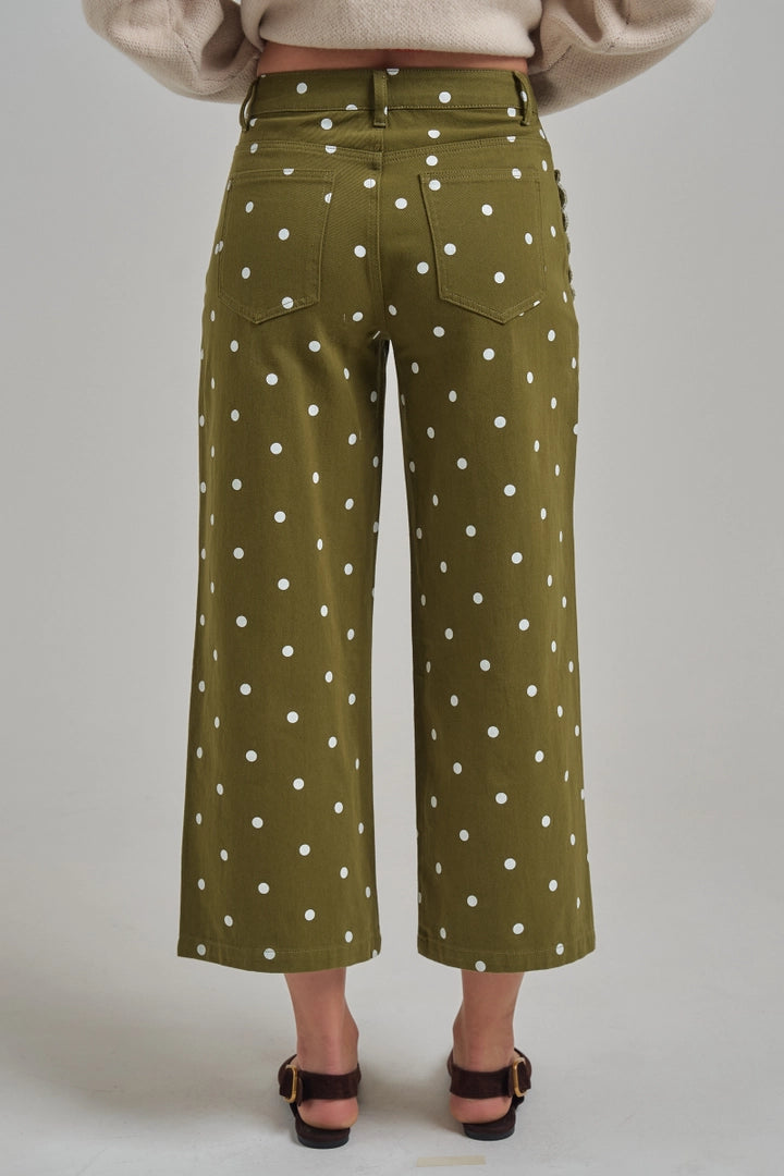 Back view of olive green polka dot wide leg pants with patch pockets and cropped length.