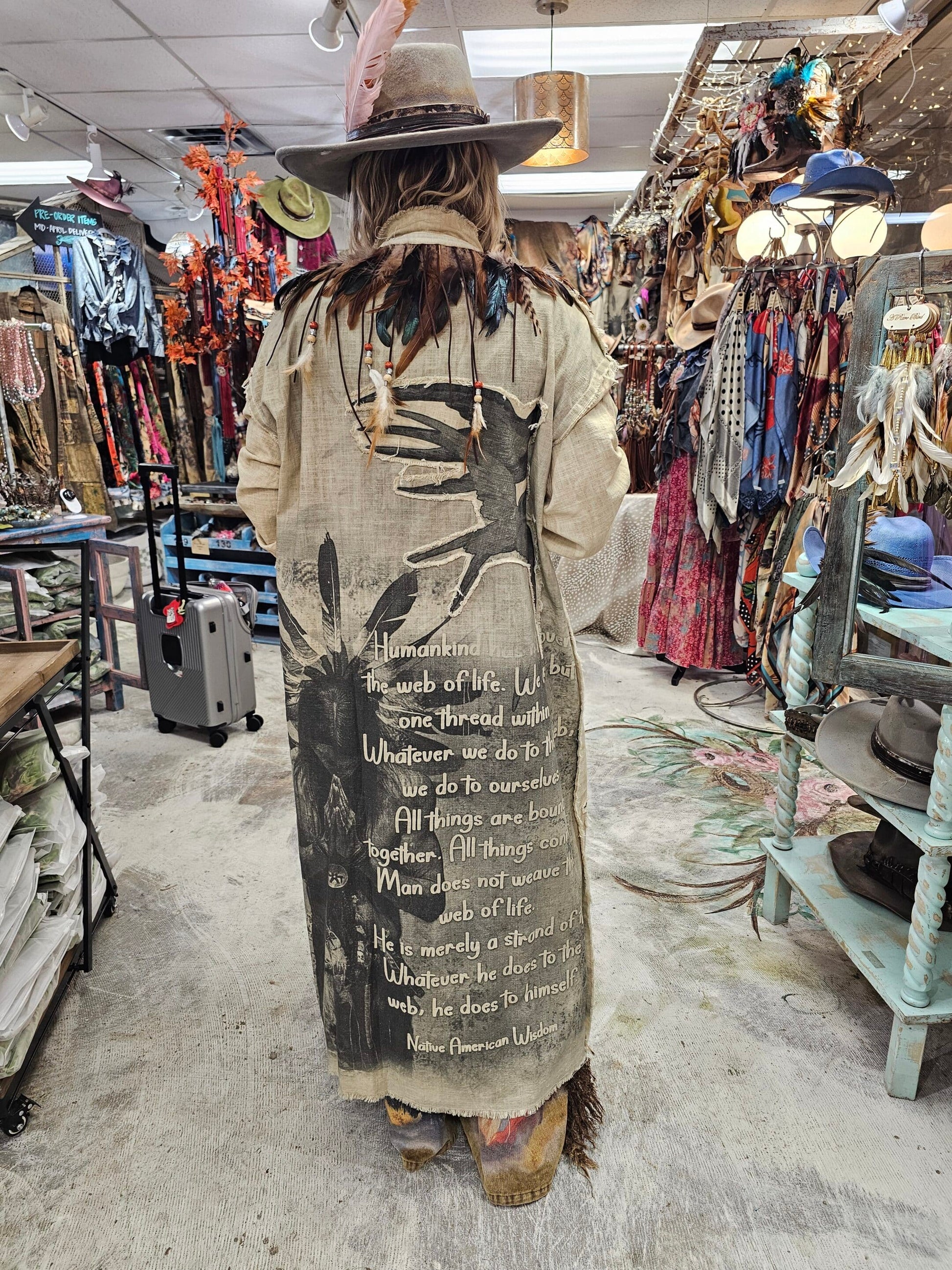 Original Artwork designed and made by A Rare Bird. This Duster does have a removable feather color that snaps on and off. Feather collar can then be worn as a choker. The duster has a Beautiful Native Amereican Princess in Prayer with a Inspirational native American Proverb adorning the back. This piece has beautiful beading on the front pockets and a raw edge hem. This piece is very roomy and will fit up to a size 18-20 comfortably. This is truly wearable art.