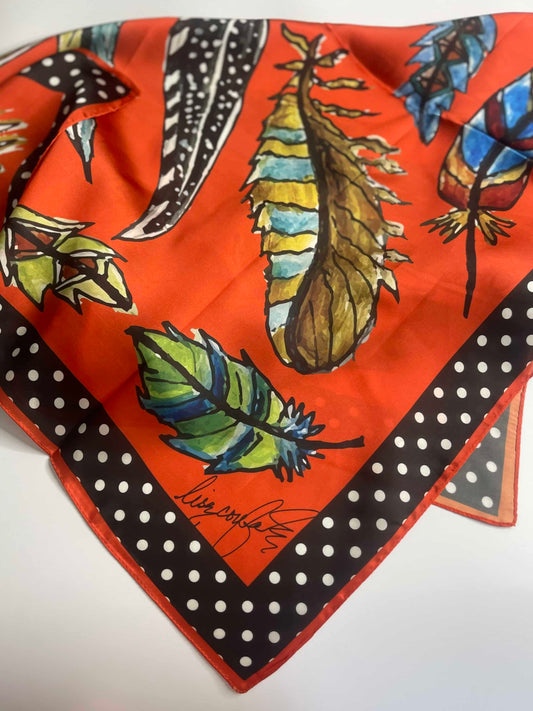 Gorgeous Wild Rag, designed by A Rare Bird, with colorful feathers against a tangerine background and Polka Dot Trim. Perfect for all Seasons, but adorable for Fall attire.