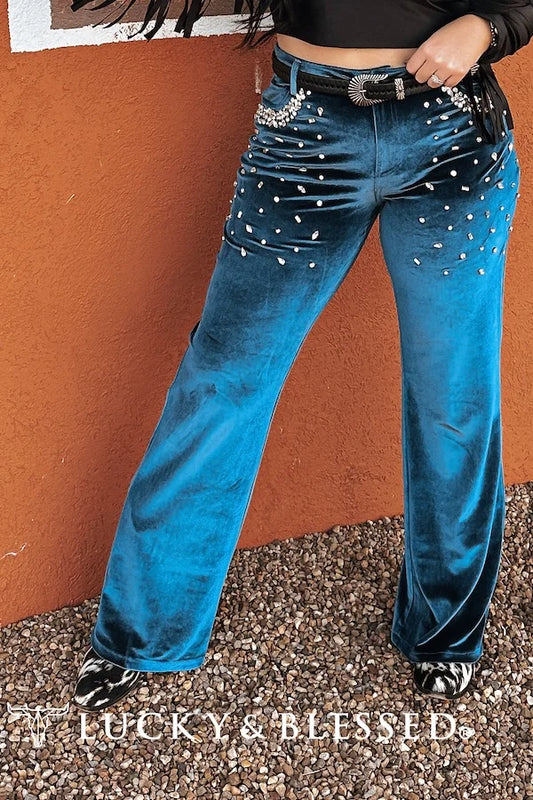 Teal Velet pants that have an amazing, comfotable, fit. They feature rhinestones around pockets that also adorn the front of pockets. Great to dress up or for a more blinged up casual look pair back with a basic-tee.