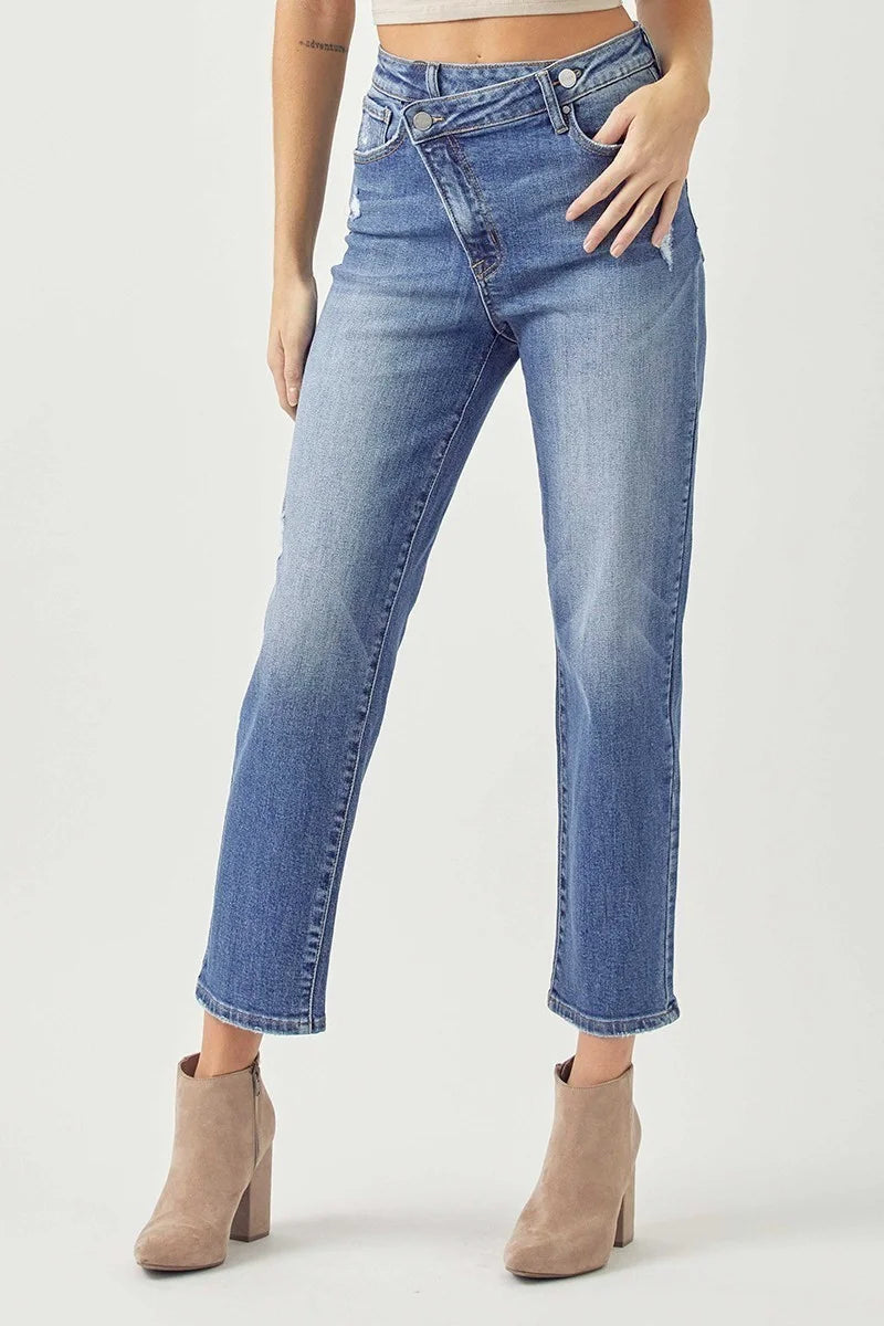 High-rise crossover tapered jeans by Risen in medium-wash denim with a sculpted fit and comfortable stretch.