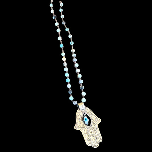 Necklace with genuine Jasper beaded chain and Hamsa hand pendant on a black background made by Artist: Tara Gasparian