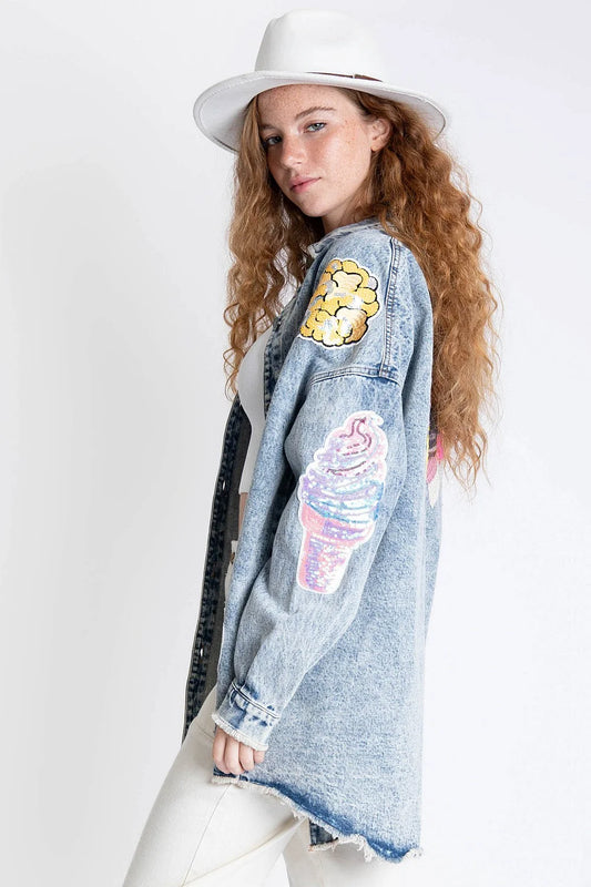 Making Memories Denim Shacket by BlueVelvet featuring whimsical sequin patches, oversized fit, front pockets, raw edge hem, rolled sleeves, and playful dog graphic on the back.