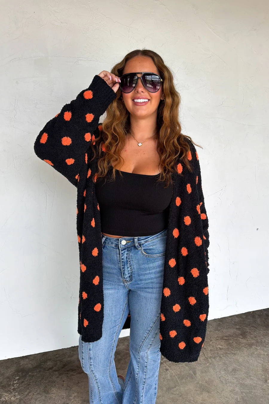 Boo Crew Reversible Cloud Cardigan by Blakeley in black with orange polka dots styled with denim