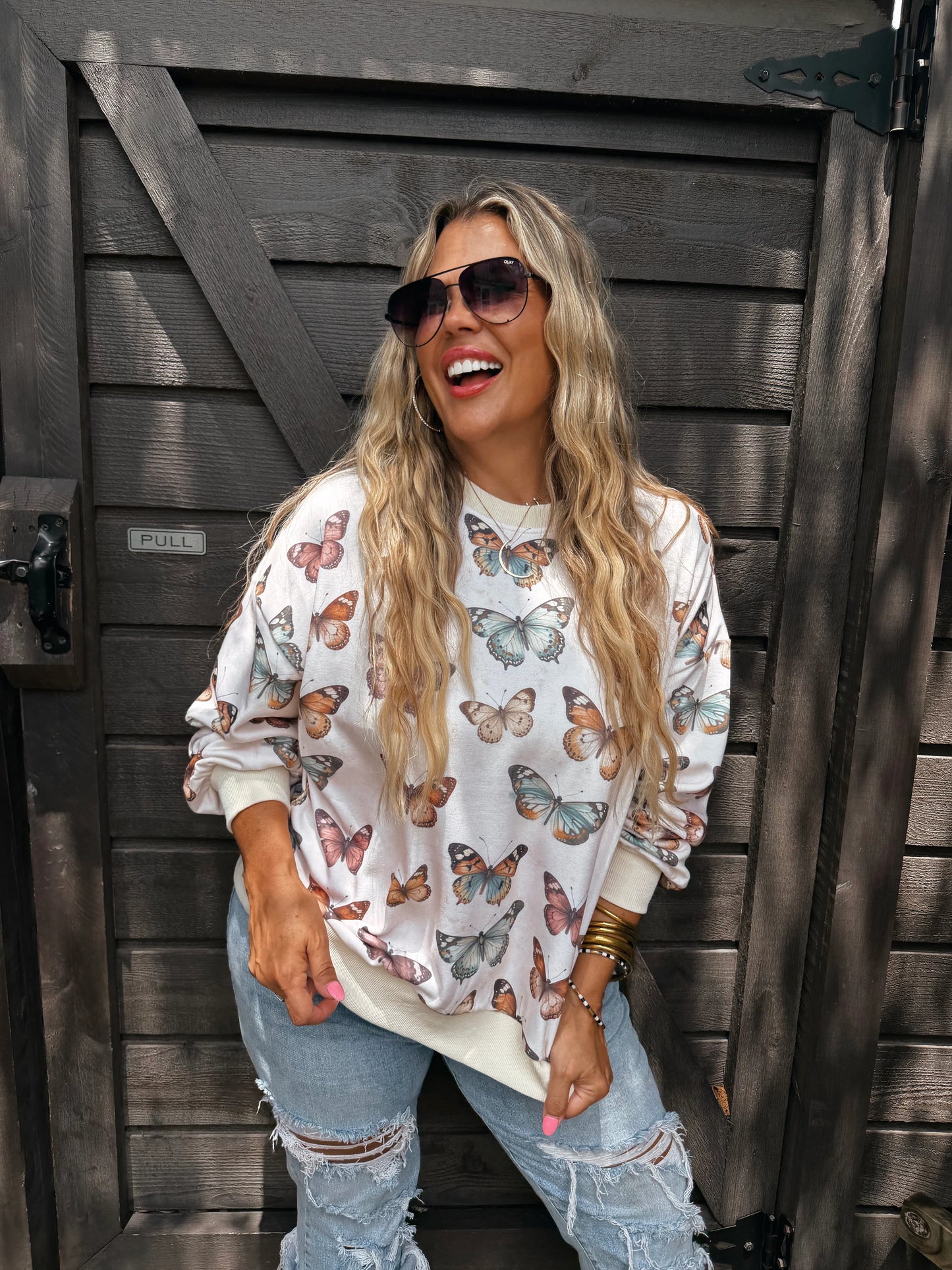 Butterfly Season Pullover by Blakeley with all-over multicolor butterfly print, relaxed crewneck fit and ribbed trim
