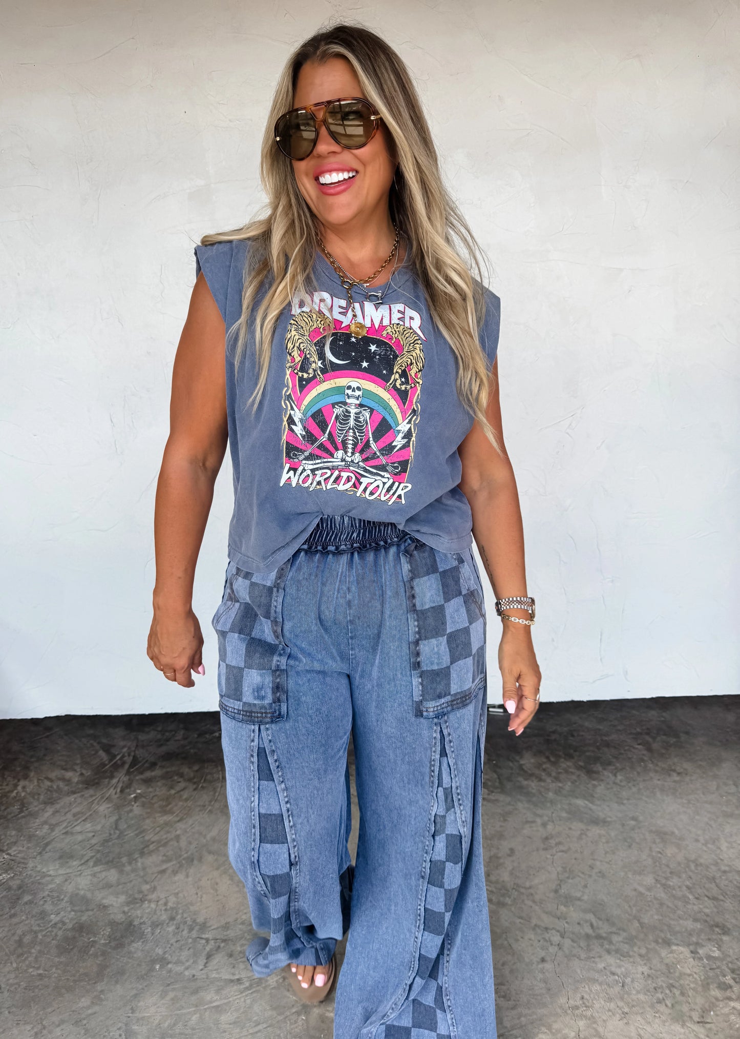 Model wearing Groove On Checkered Flare Pants by Blakeley featuring a bold checker print and flared leg silhouette
