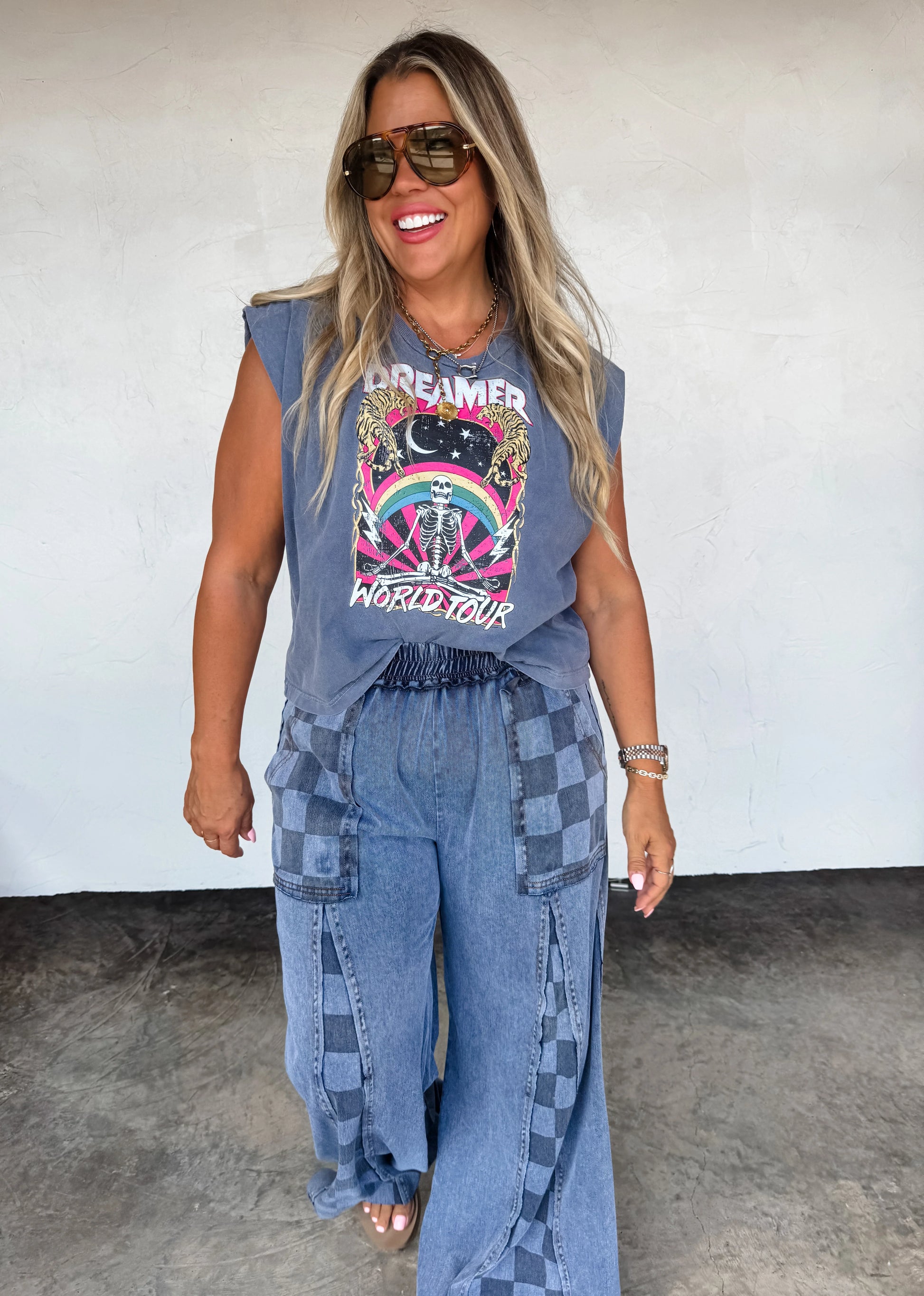 Model wearing Groove On Checkered Flare Pants by Blakeley featuring a bold checker print and flared leg silhouette
