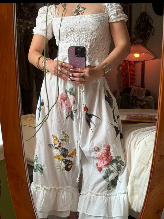 Boho floral bloomers with bird and fruit print, ruffle hem, and adjustable drawstring waist styled in a romantic cottagecore outfit
