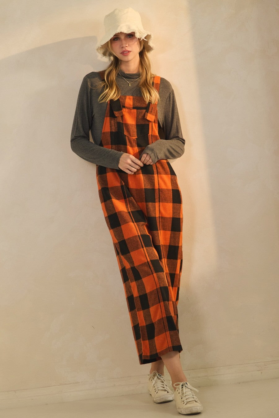 Orange and black buffalo plaid cropped overalls with wide leg fit and adjustable straps styled for fall outfit