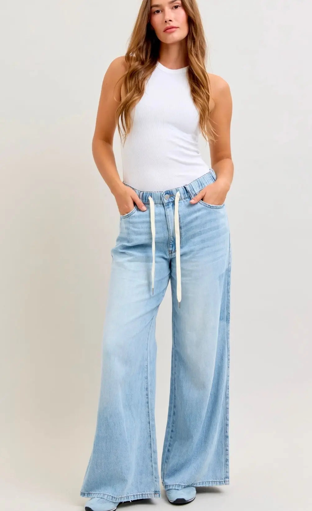 Light wash Judy Blue featherweight palazzo pants with wide leg fit, elastic waistband, and drawstring detail styled casually