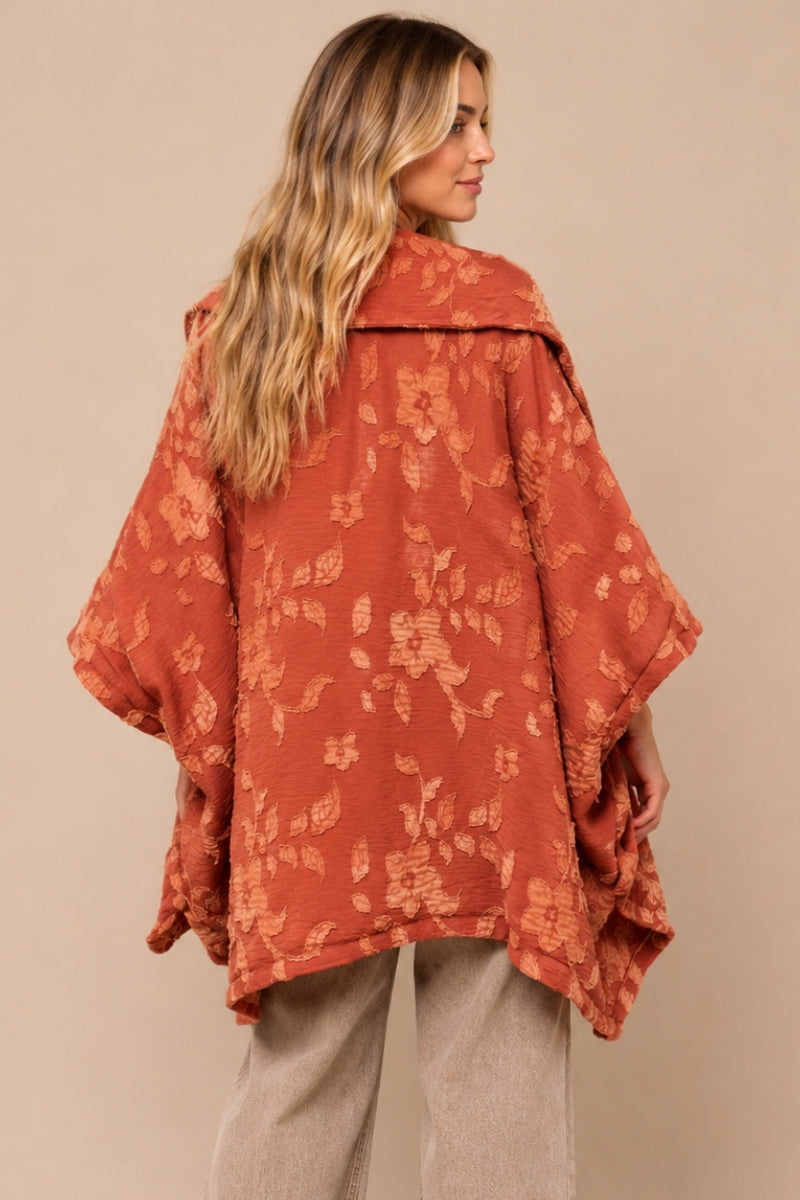 Back view of J.NNA brick kimono jacket featuring raised peach floral appliques and an oversized relaxed silhouette