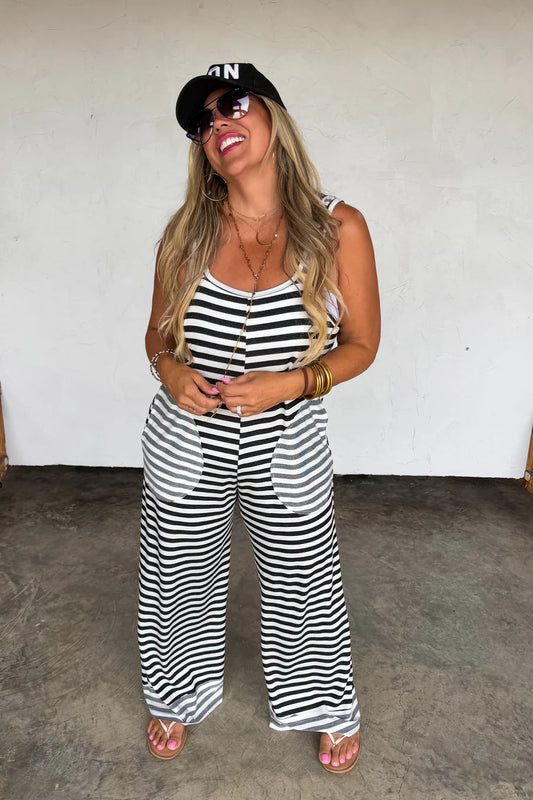 Ricki Stripe Terry Romper by Blakeley featuring black and ivory stripes, ultra-soft baby terry fabric, oversized side pockets, sleeveless wide-leg silhouette, and relaxed stretch fit.