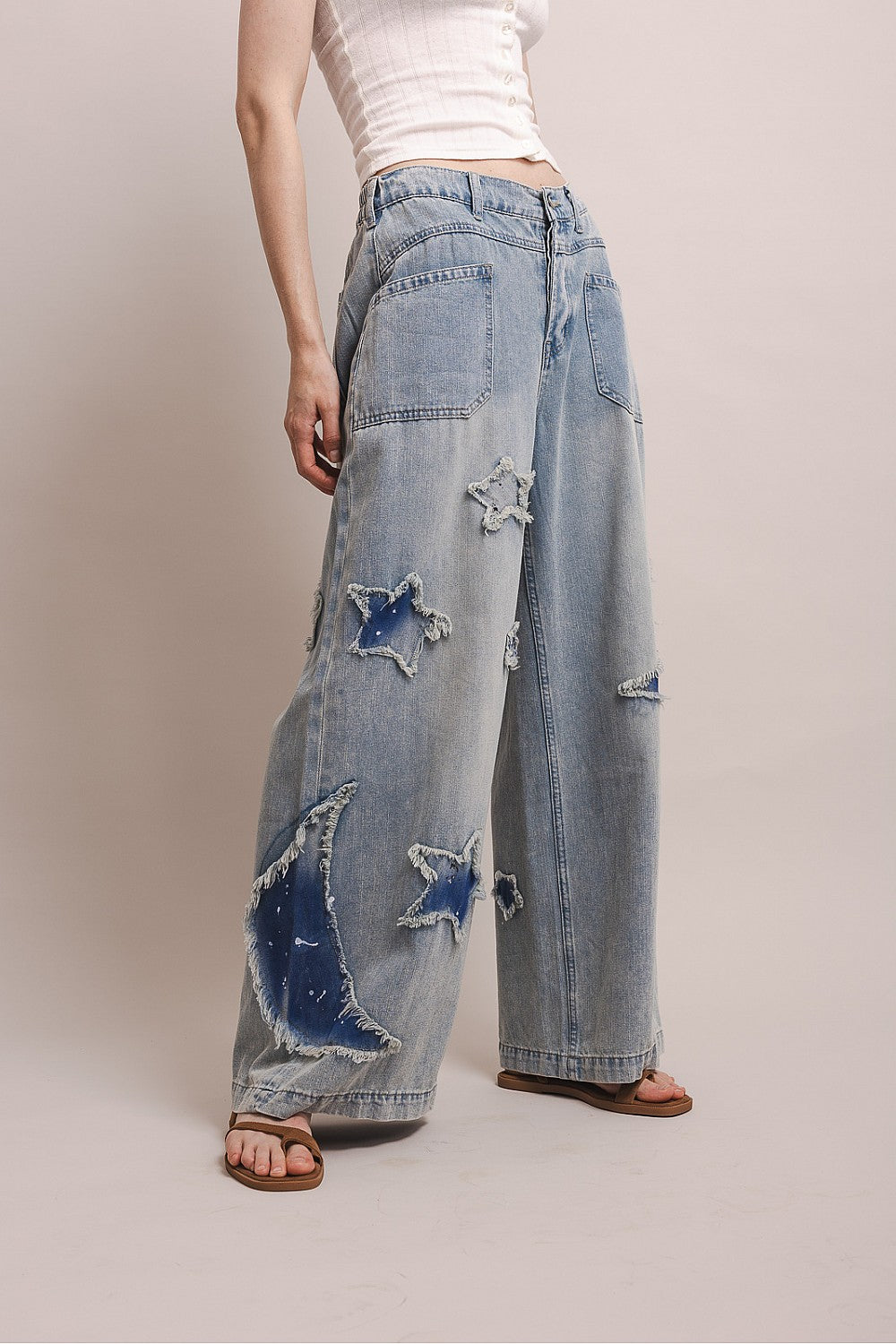 Wide leg denim pants with distressed star patches and elastic back waistband in a relaxed fit by BlueVelvet