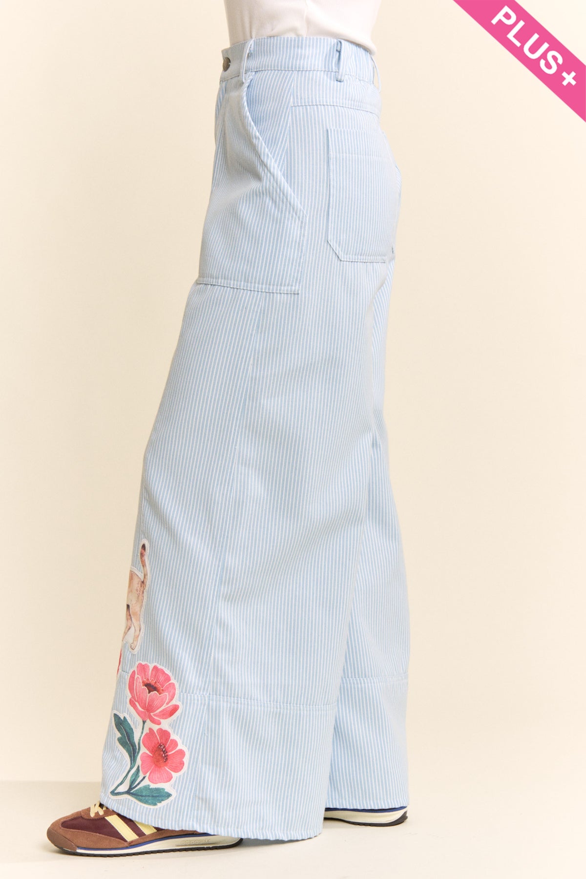Side view of Davi & Dani light blue pinstripe wide leg pants with floral applique detail