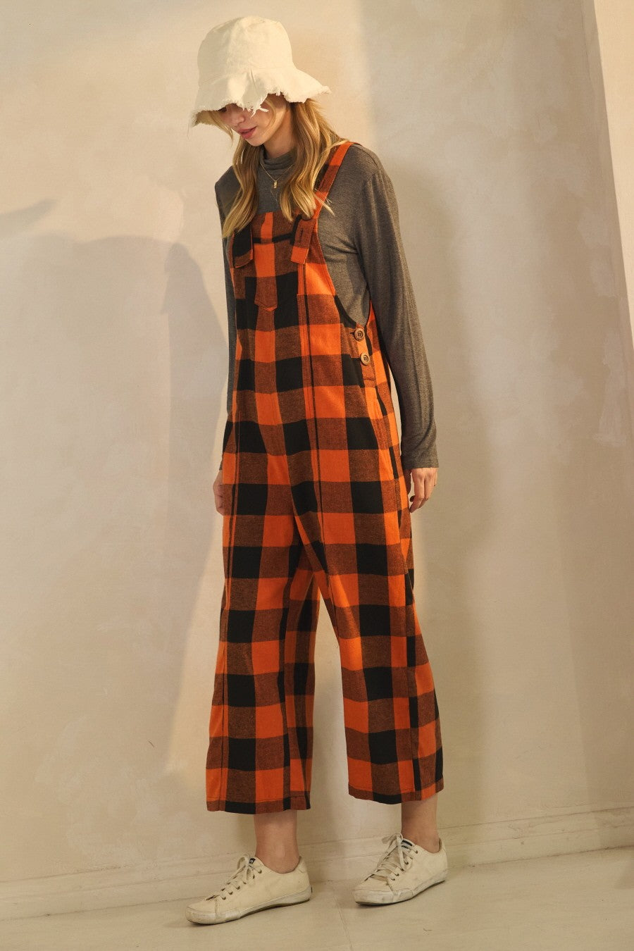 Orange and black buffalo plaid cropped overalls with wide leg fit and adjustable straps styled for fall outfit
