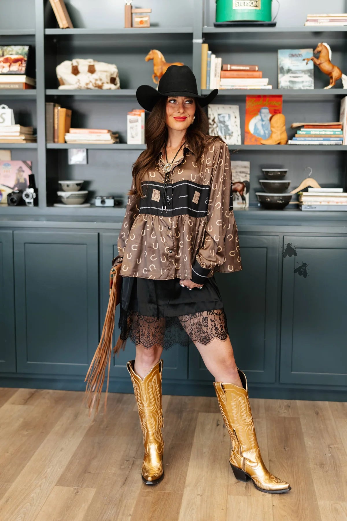 Black lace Ex-Tendy skort by 2Fly styled with a western-inspired blouse and tall boots