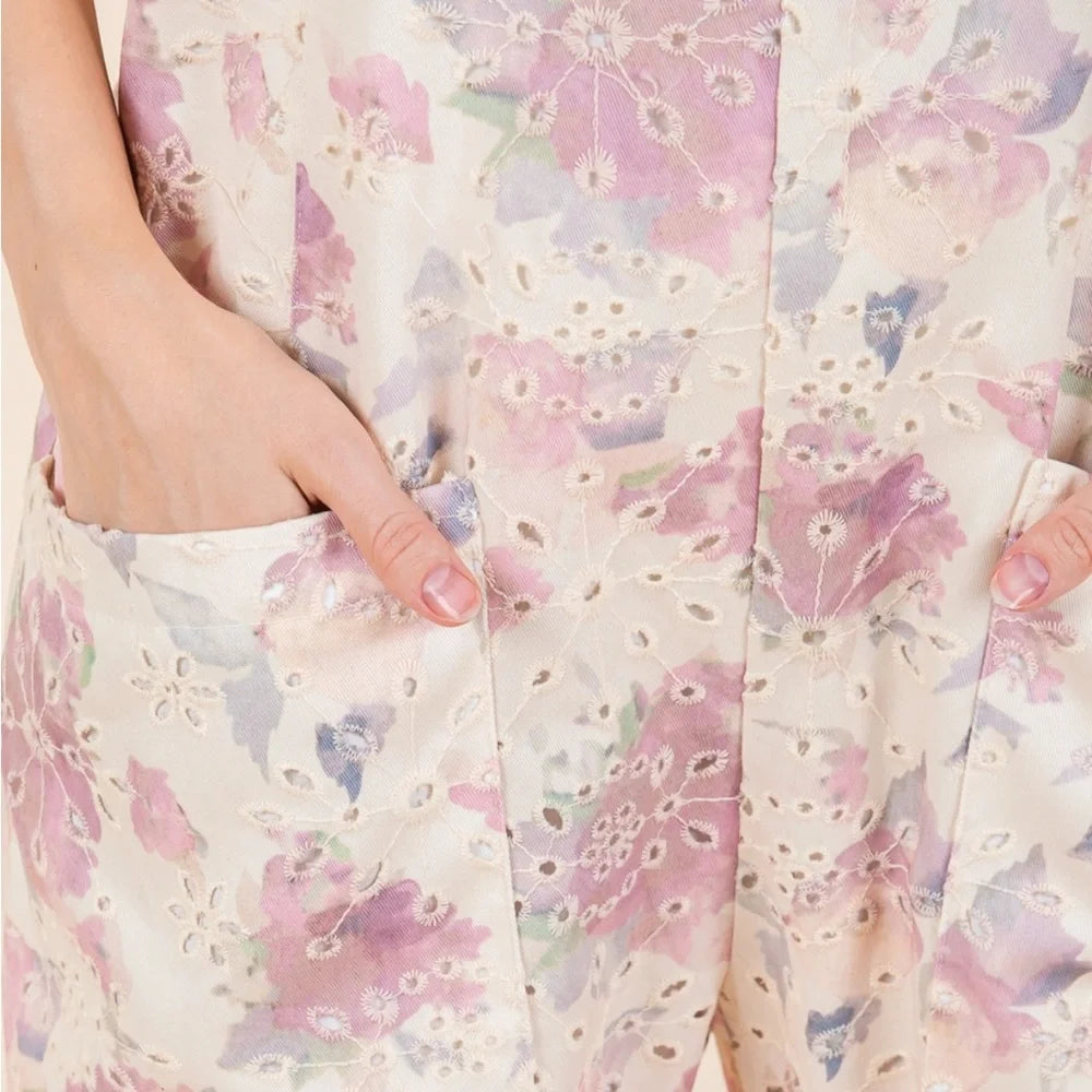 Close-up of the floral eyelet embroidered fabric on the Petal & Promise Eyelet Jumpsuit by Gee Gee.