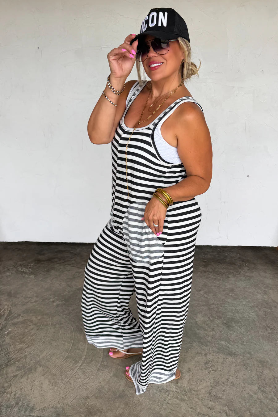 Ricki Stripe Terry Romper by Blakeley featuring black and ivory stripes, ultra-soft baby terry fabric, oversized side pockets, sleeveless wide-leg silhouette, and relaxed stretch fit.